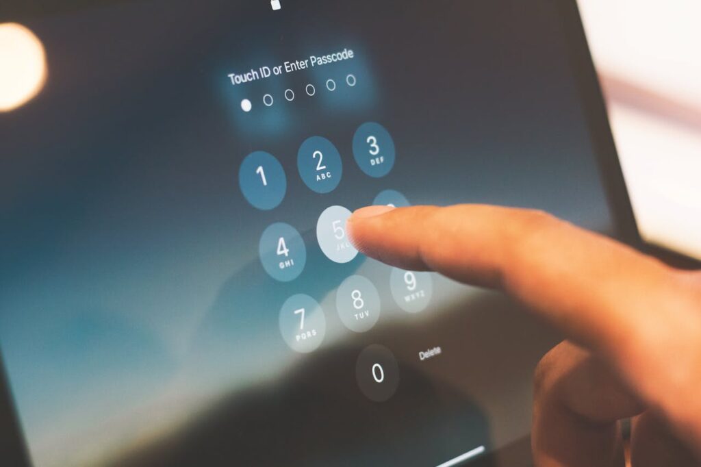 pexels photo 27742642 Close-up of a finger entering a passcode on a smartphone security screen.
